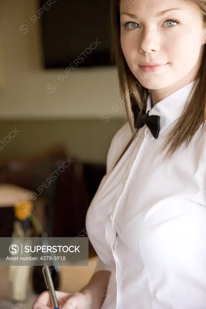 Portrait of a waitress holding a pen