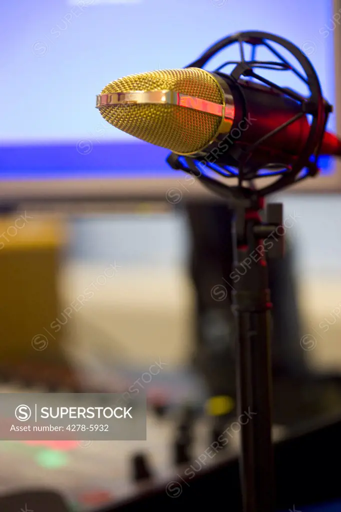 Close up of a gold microphone on a pedestal