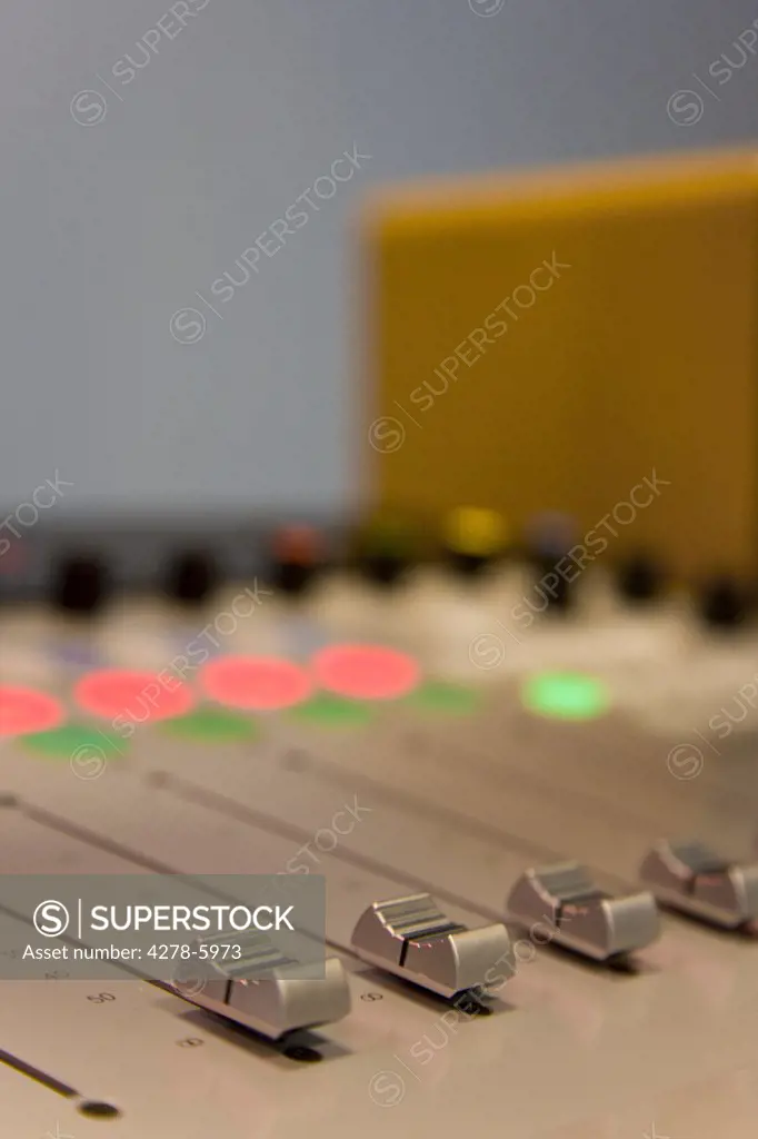 Close up of a mixing board in a recording studio