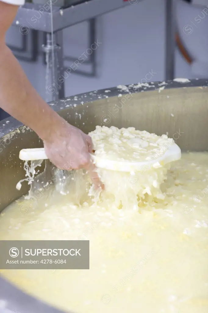 Close up of a man's hand sifting cheese