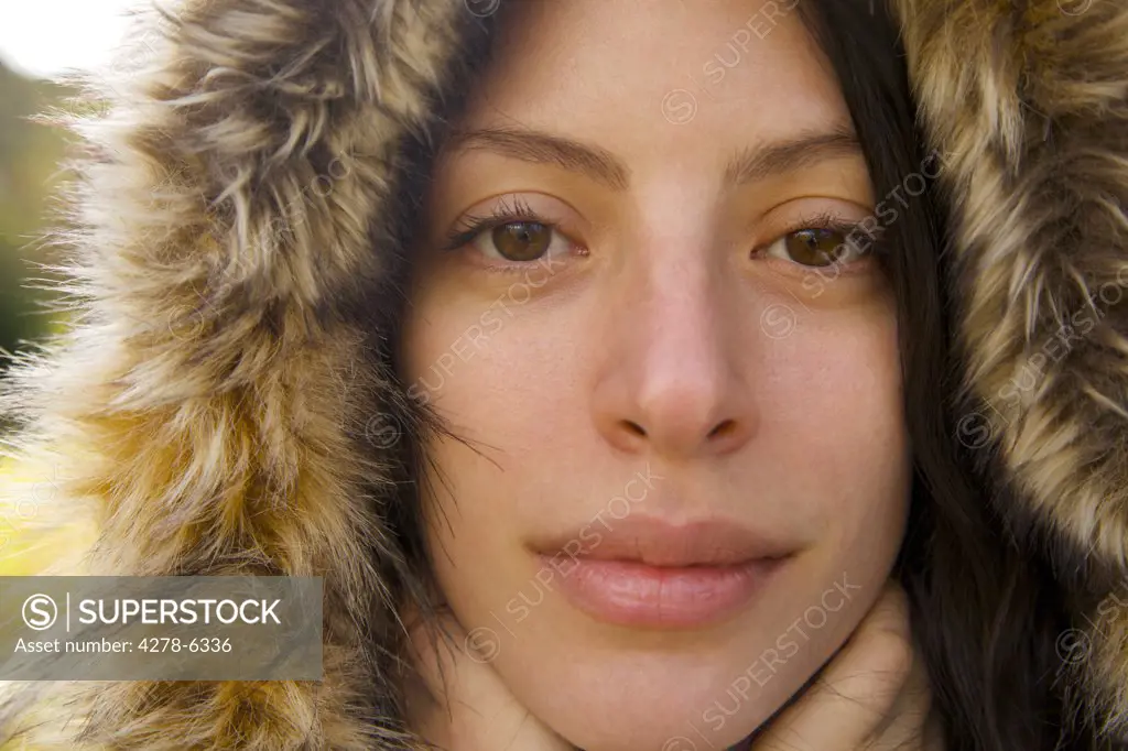 Close up of a young woman wearing a hooded parka