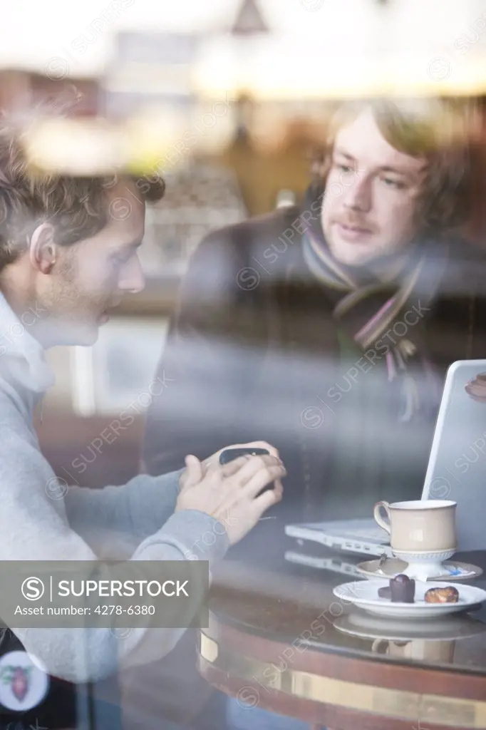 Two men talking in a cafe