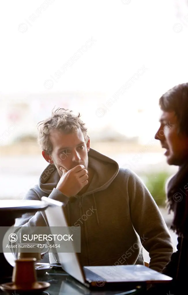 Two men talking in a cafe