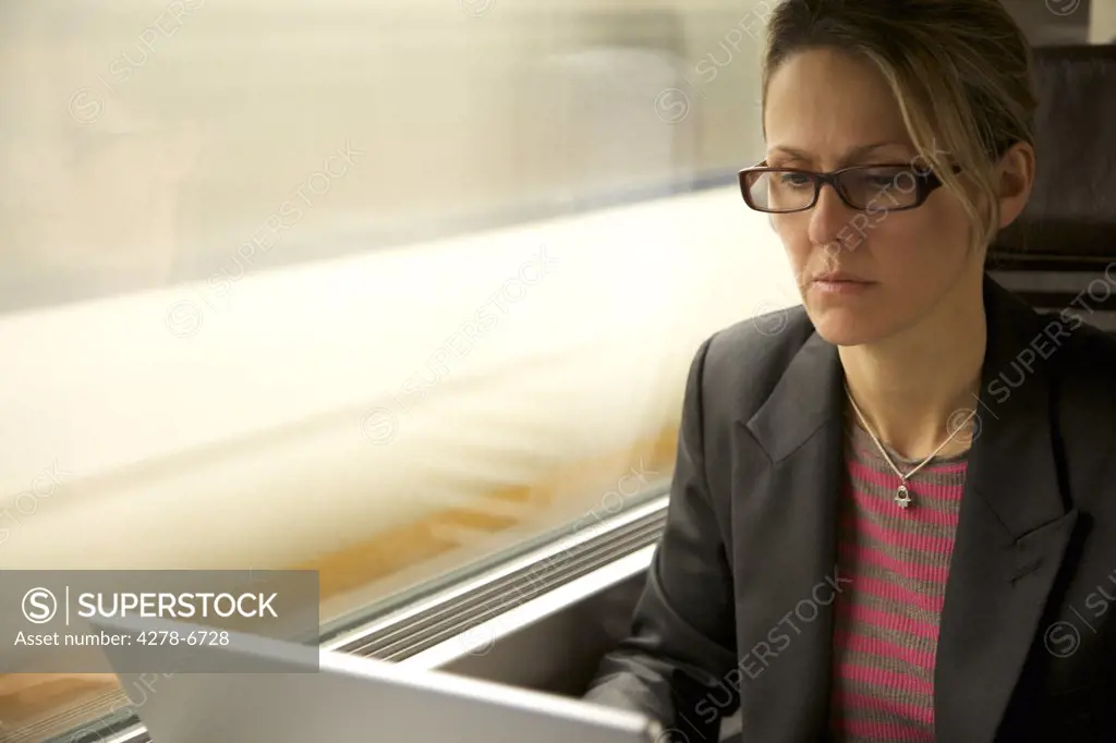 Woman on train using laptop computer