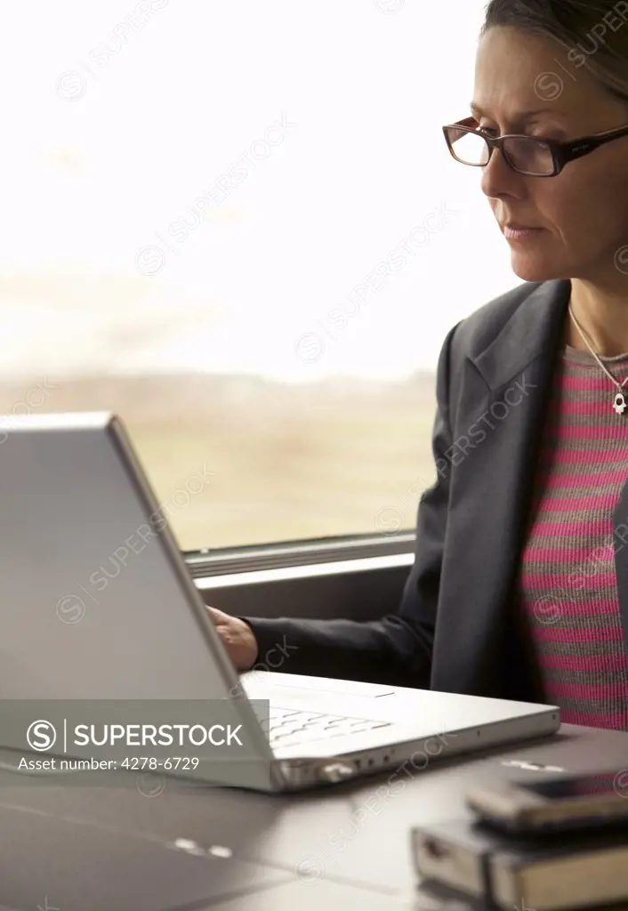 Woman on train using laptop computer