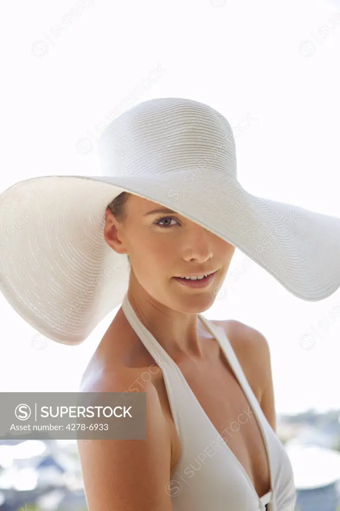 Close up of a young woman wearing a white hat