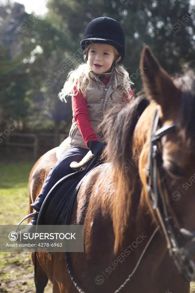 Young girl riding a horse
