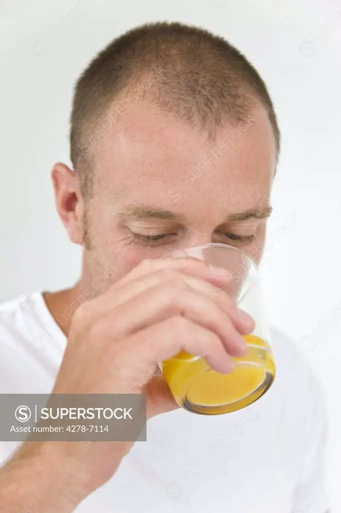 Man Drinking Orange Juice