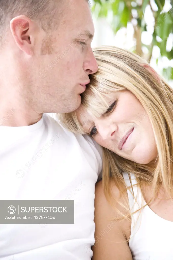 Man Kissing Woman's Forehead