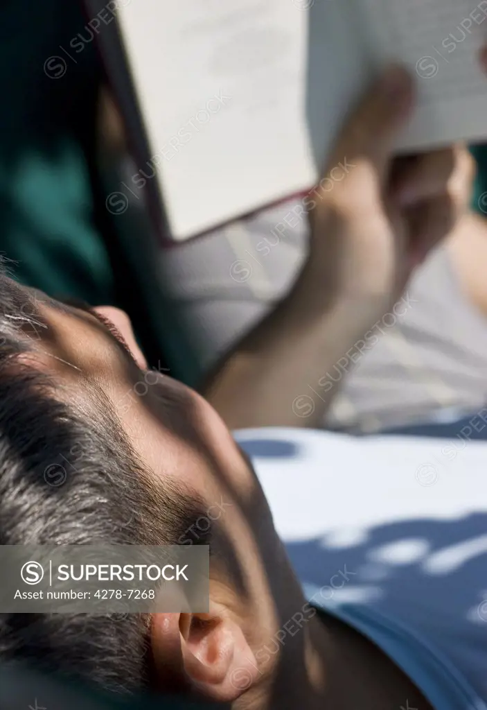 Man Reading Book on Hammock