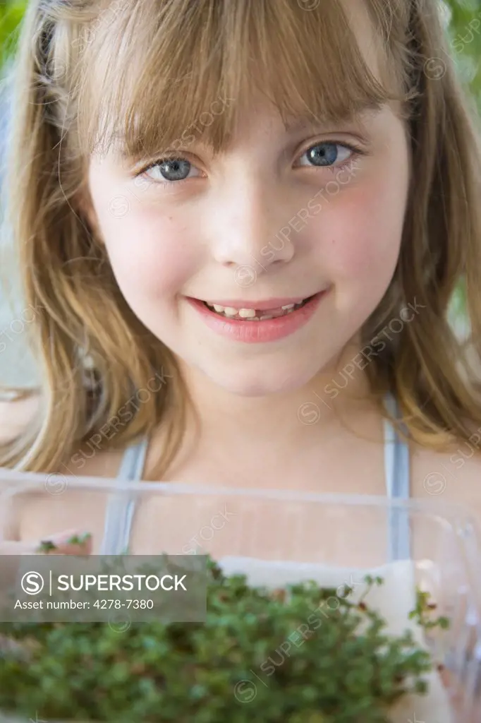 Young Girl Holding Watercress Seedlings