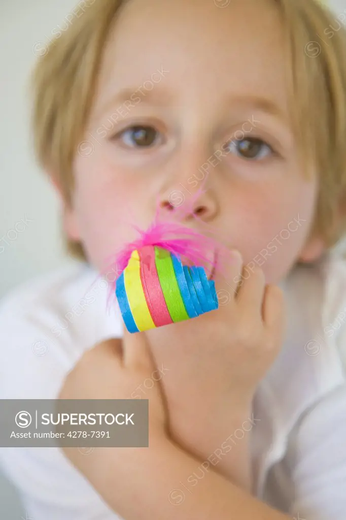 Boy Blowing Party Blower