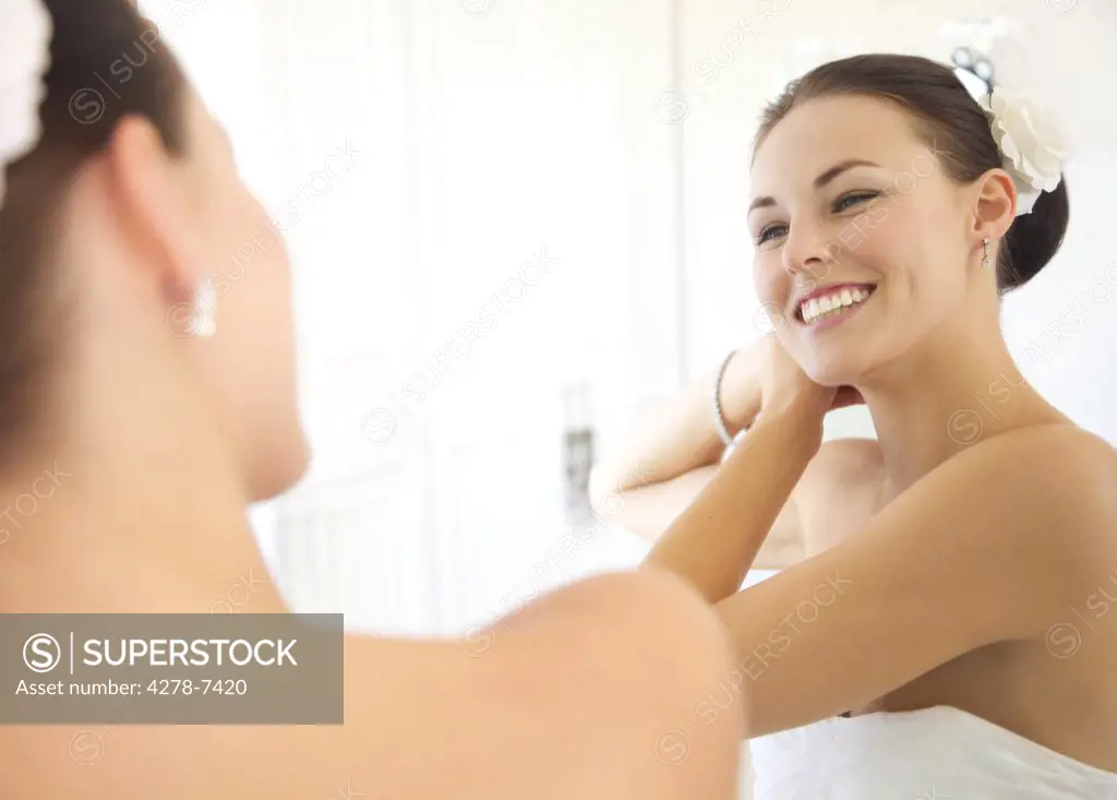Mirror Image of Woman Adjusting Hair