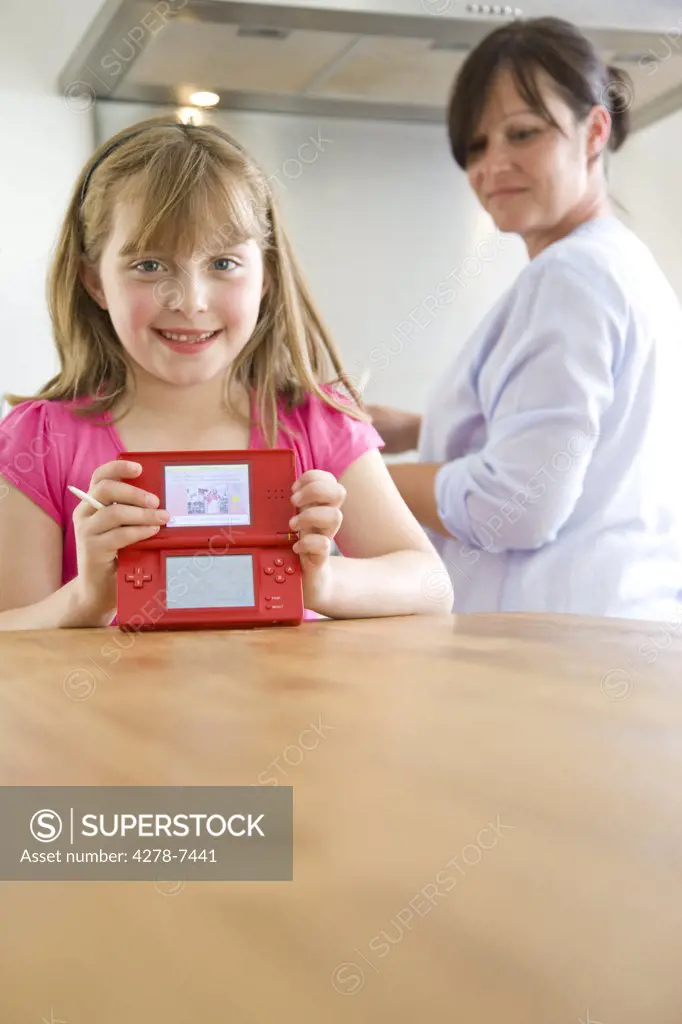 Smiling Girl Holding Video Game