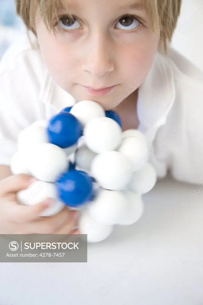 Boy Holding Atom Model