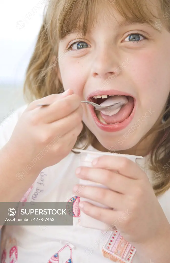 Young Girl Eating Yogurt