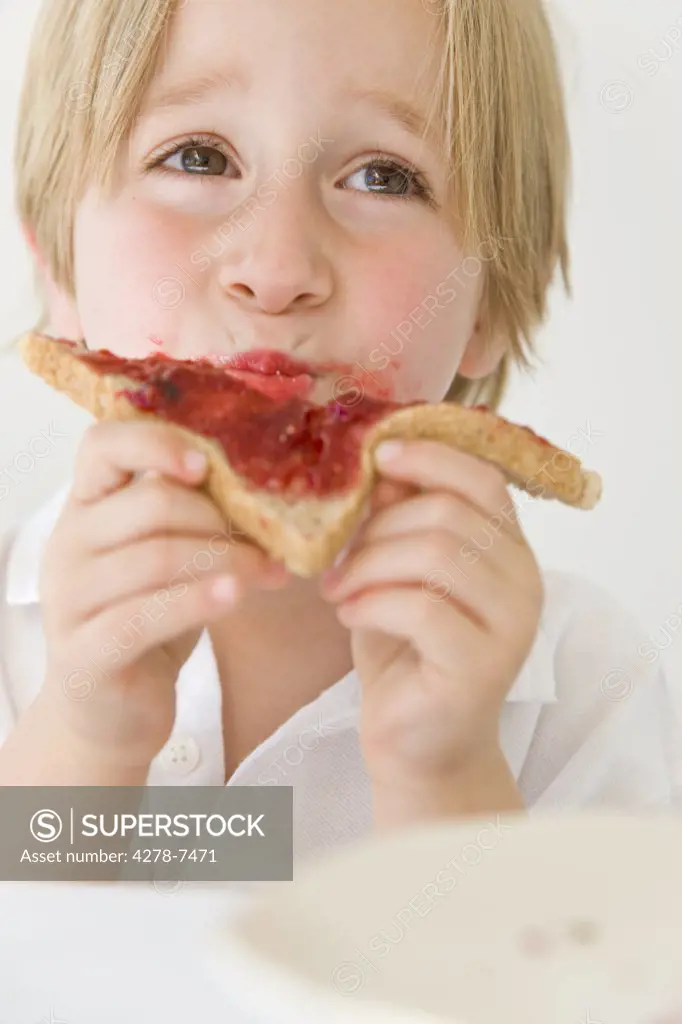 Boy Eating Jam on Toast