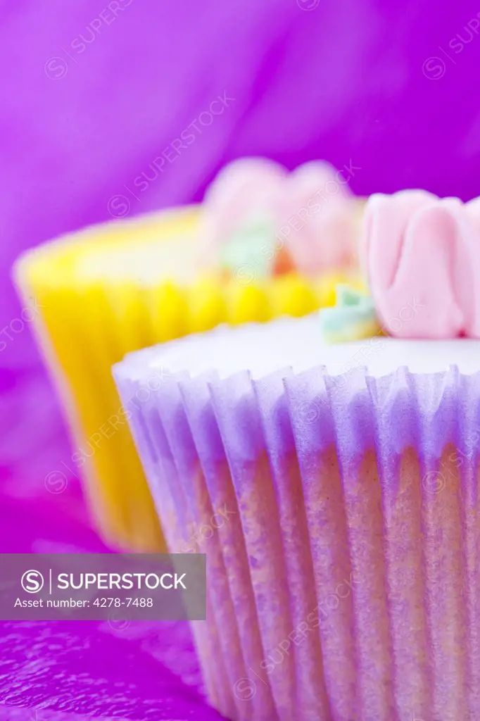 Pink and  Yellow Cupcakes with Pastel Pink Flower Decoration