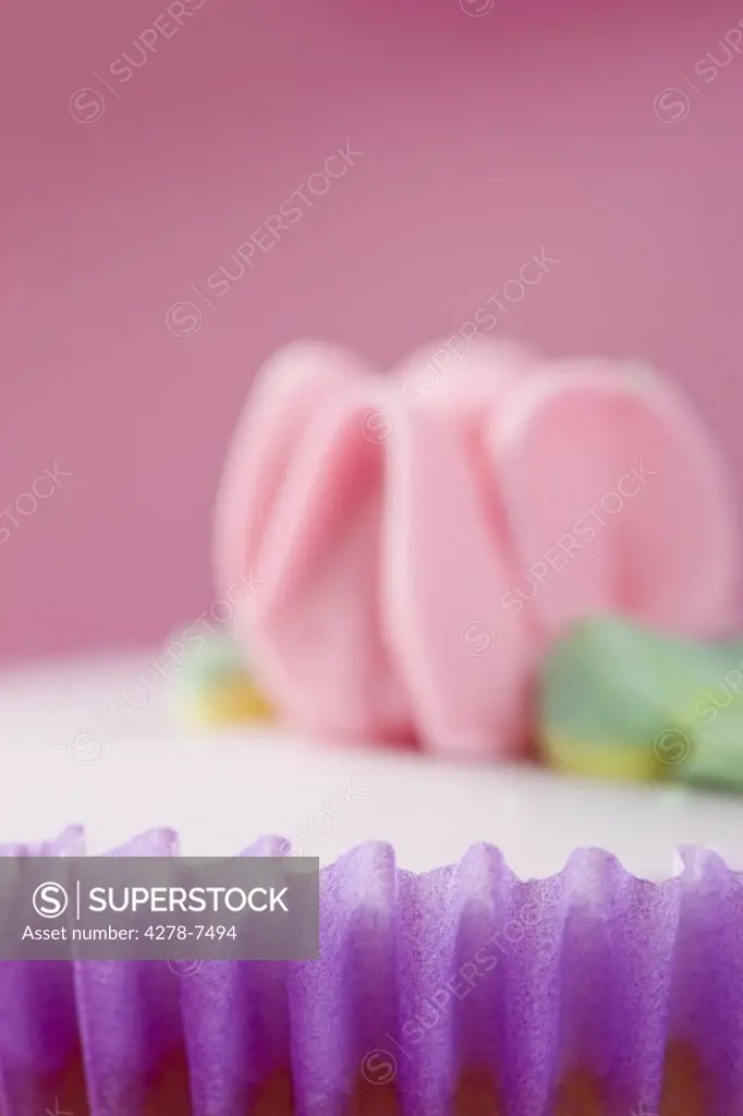 Purple Cupcake with Pastel Pink Flower Decoration