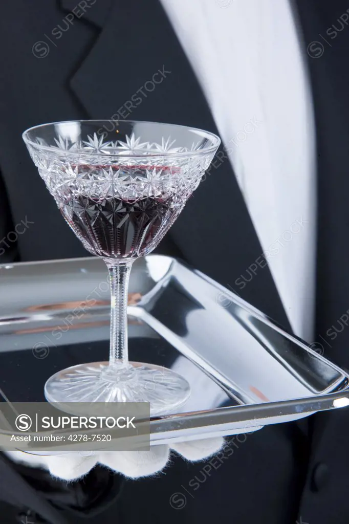 Waiter Holding Tray with Glass of Port