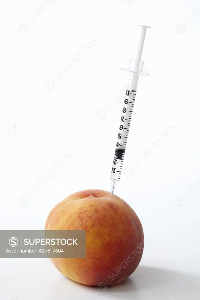 Hypodermic Needle Inserted in a Peach