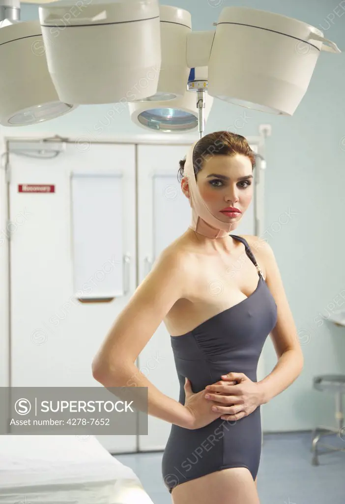 Woman with Elastic Bandage on Face Standing under Surgical Lamp