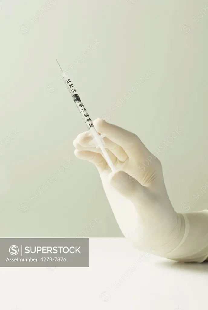 Hand Holding Syringe