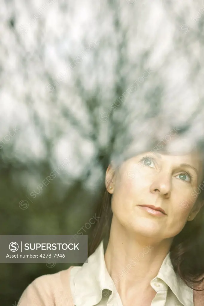 Woman Standing behind Window