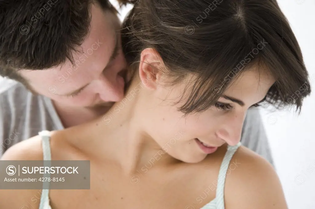 Man Kissing Back of Woman Neck