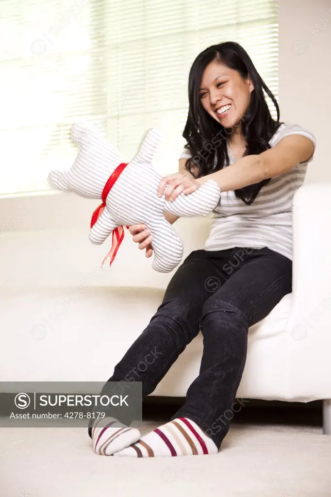 Teenage Girl Playing with Stuffed Toy