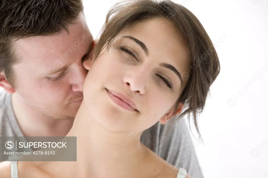 Man Kissing Back of Woman Neck