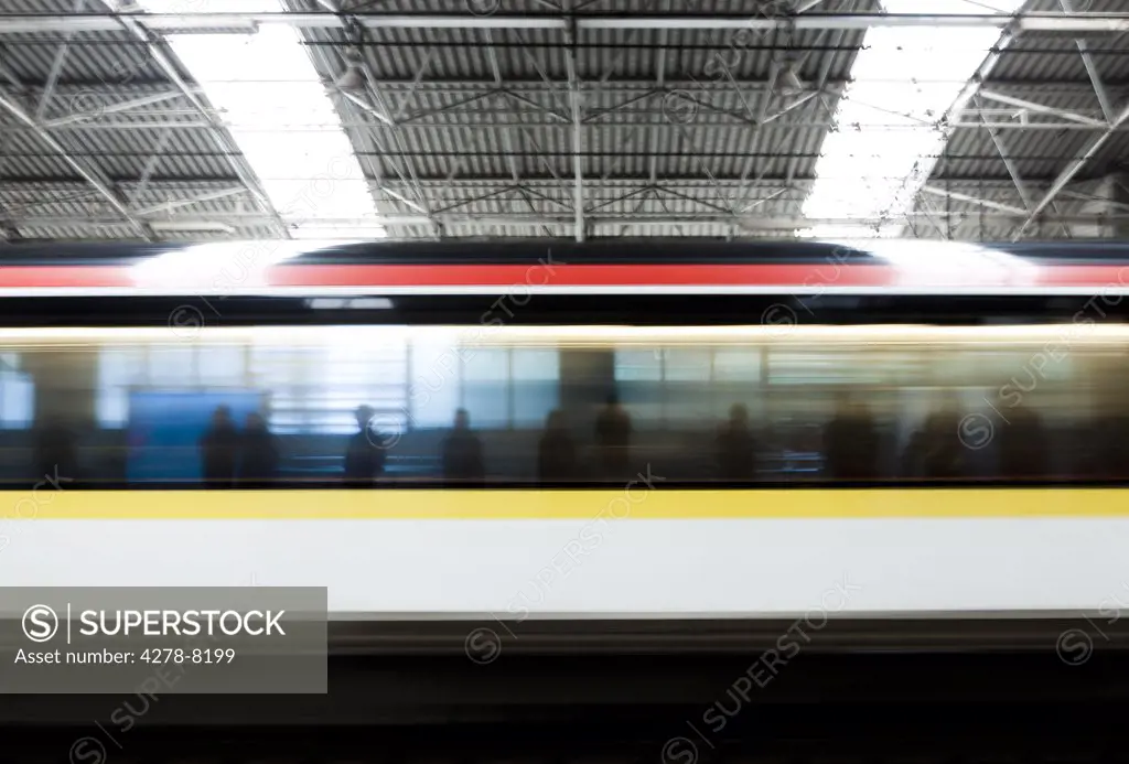 Silhouettes of People Reflecting onto Fast Moving Train