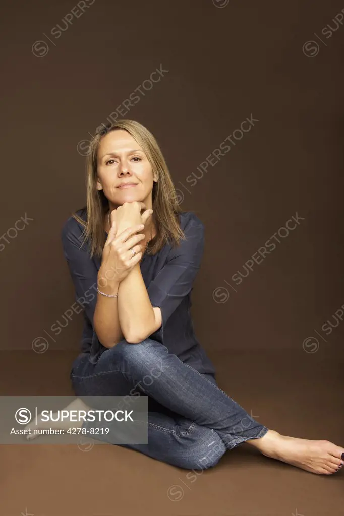 Woman Sitting Cross Legged Leaning on Elbows