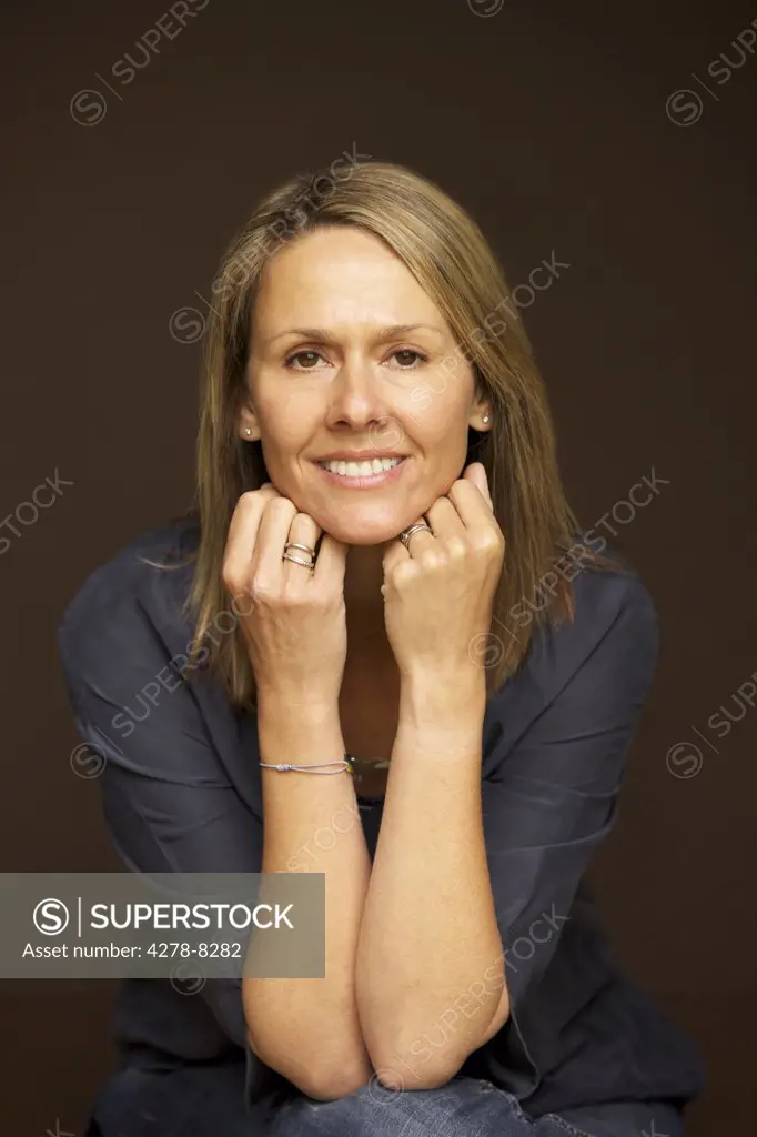 Smiling Woman Leaning on Elbows