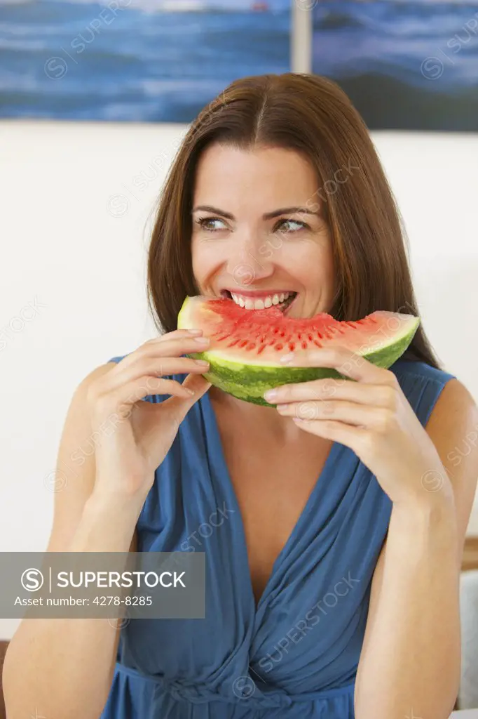 Woman Biting a Slice of Watermelon