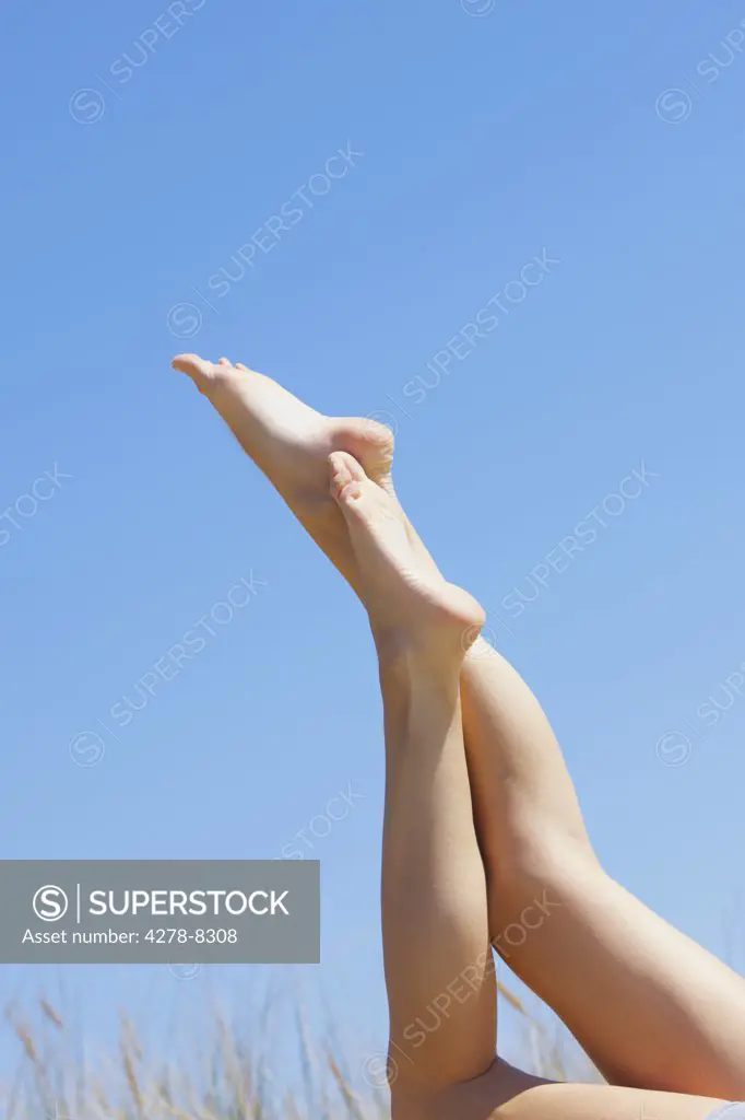 Woman's Legs against Blue Sky