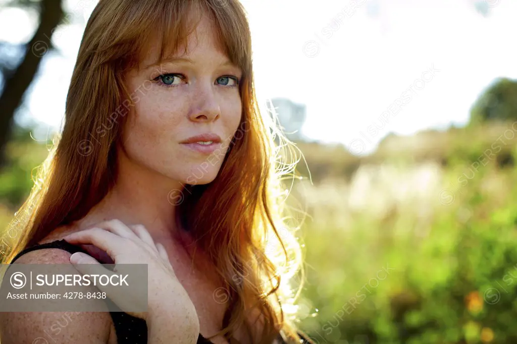 Young Woman with Red Hair Outdoors