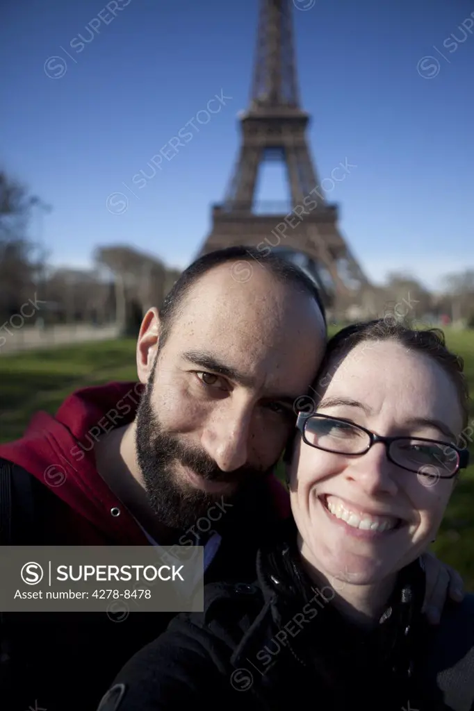 Smiling Couple in front of the Eiffel Tower