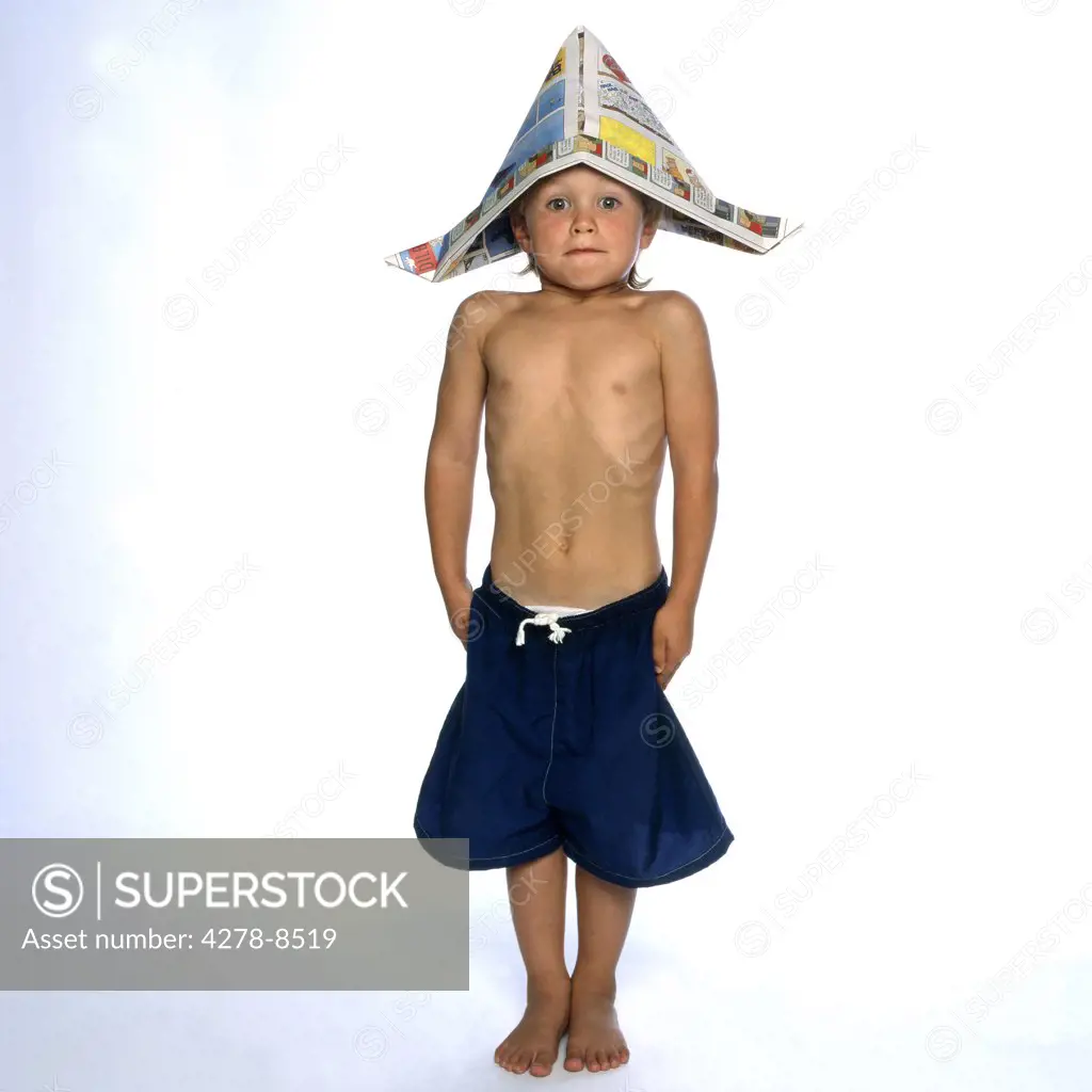 Boy Wearing Newspaper Hat Standing Straight and Stiff