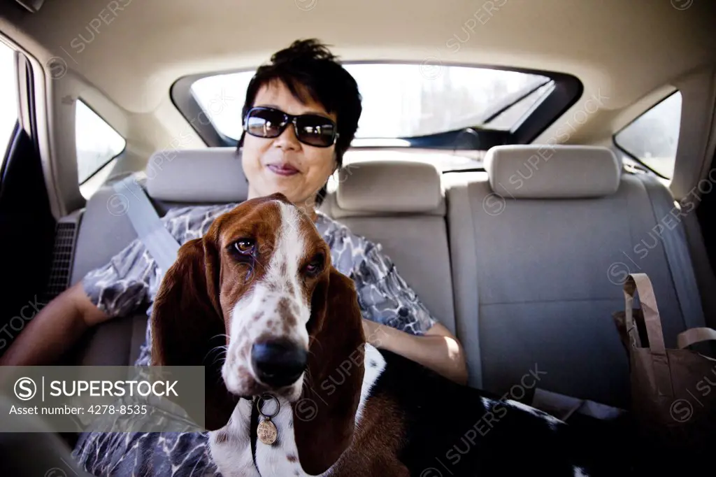 Woman and Dog in Car Back Seat