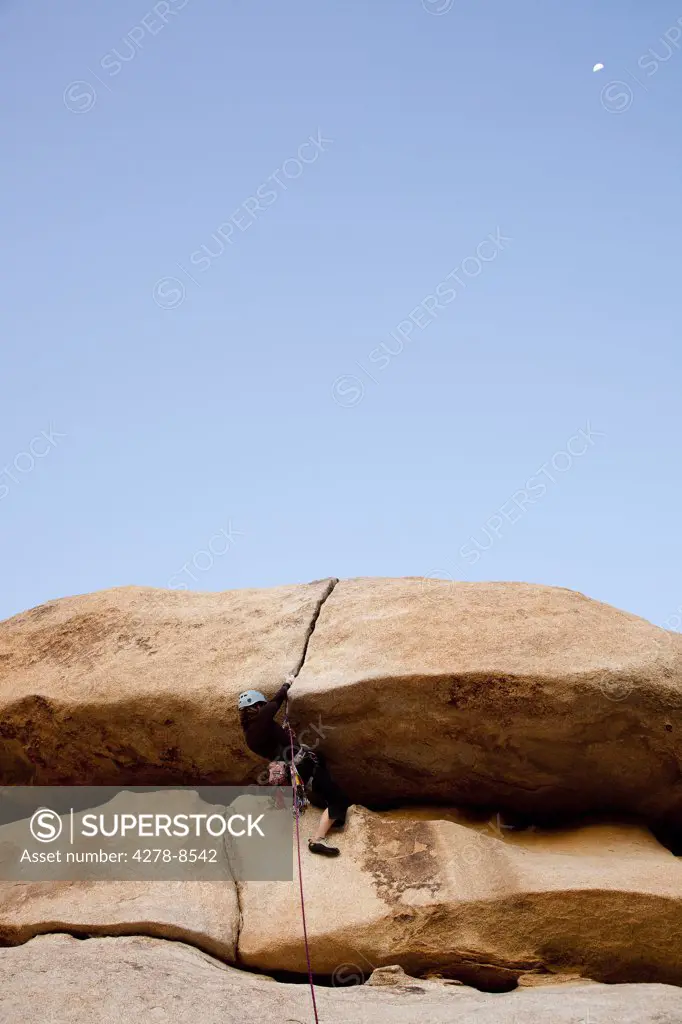 Man Climbing Rock Face