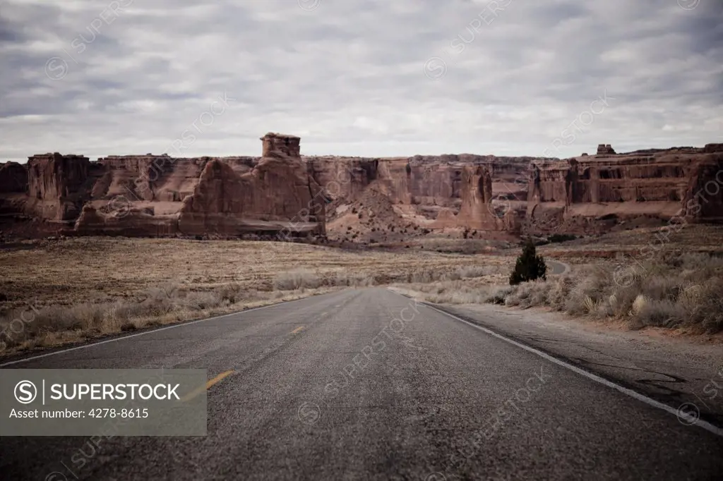 Deserted Road and Sandstone Formations