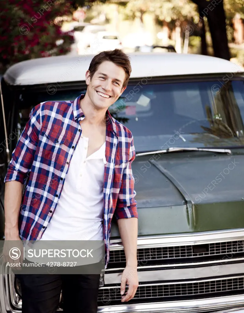 Smiling Man Standing in front of Car