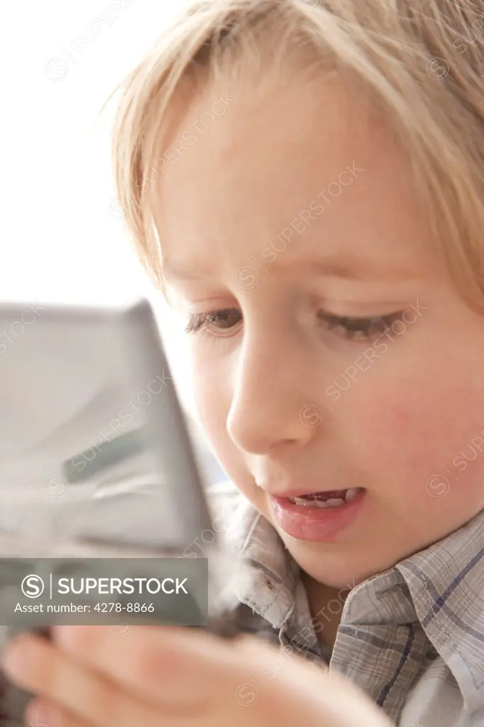 Boy Playing with Handheld Video Game