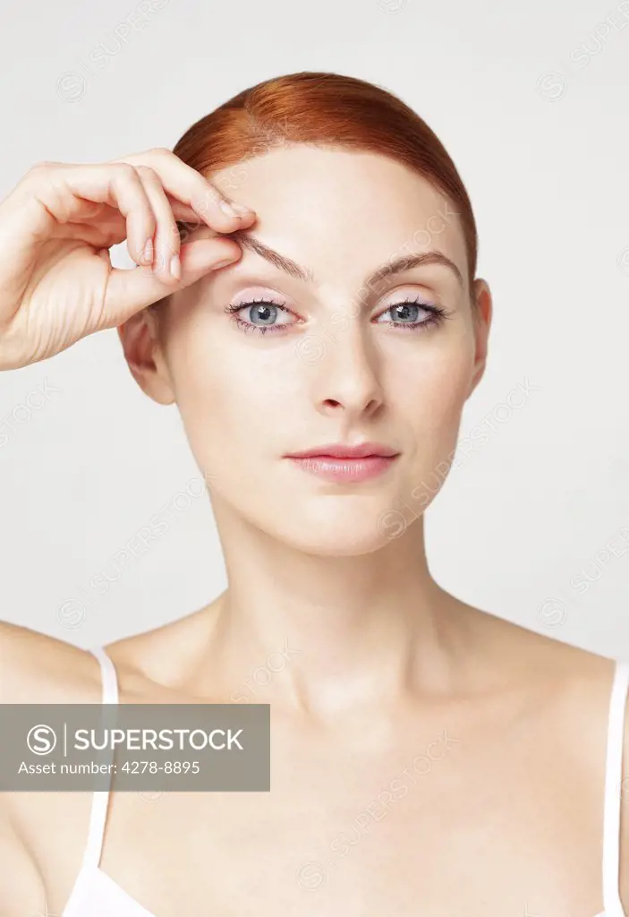 Woman Lifting Eyebrow with her Hand