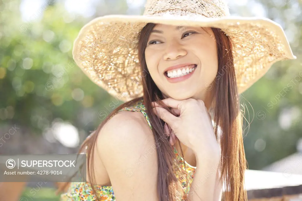 Smiling Woman Wearing Straw Hat