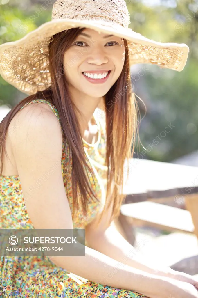 Smiling Woman Wearing Straw Hat