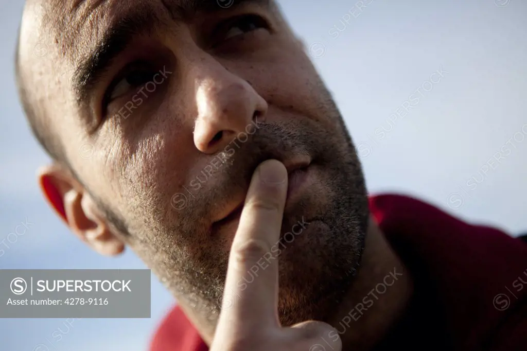 Close up of Man with Finger on Lips