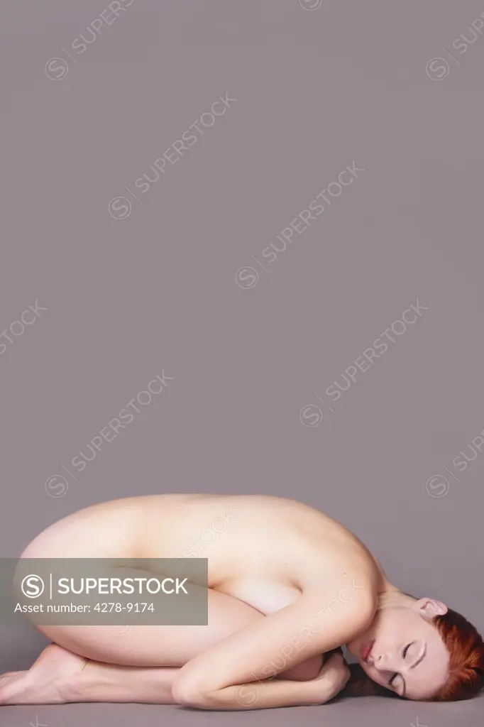 Nude Woman Curled Up on Floor