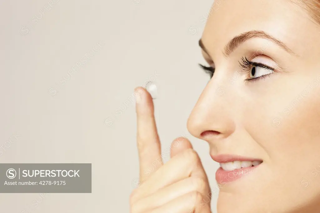 Close up Profile of Woman Putting on Contact Lens